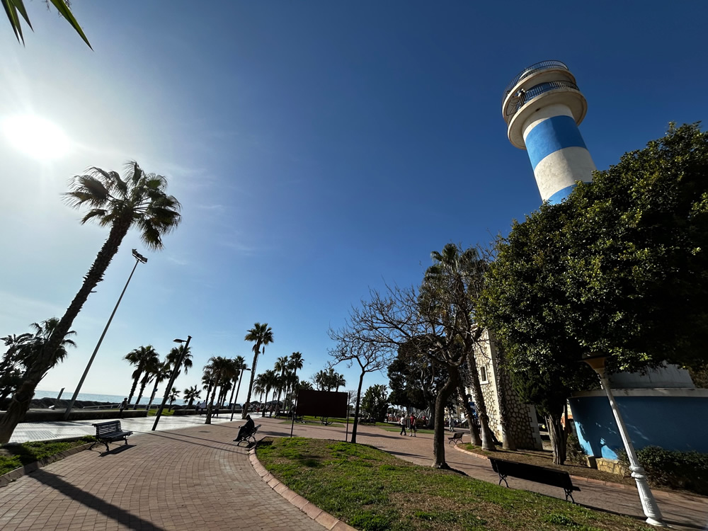 The iconic blue-and-white tower on the Torre del Mar promenade